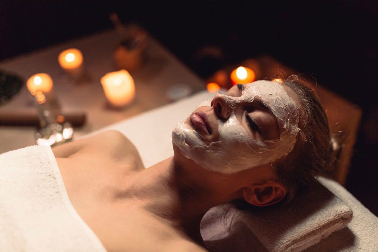 Relaxing facial treatment with a face mask applied in a spa setting