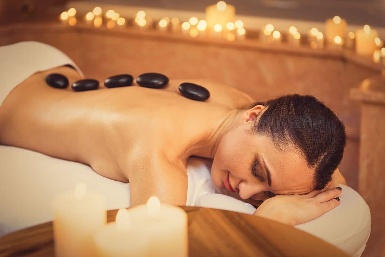 Hot stone massage with heated stones placed across the back