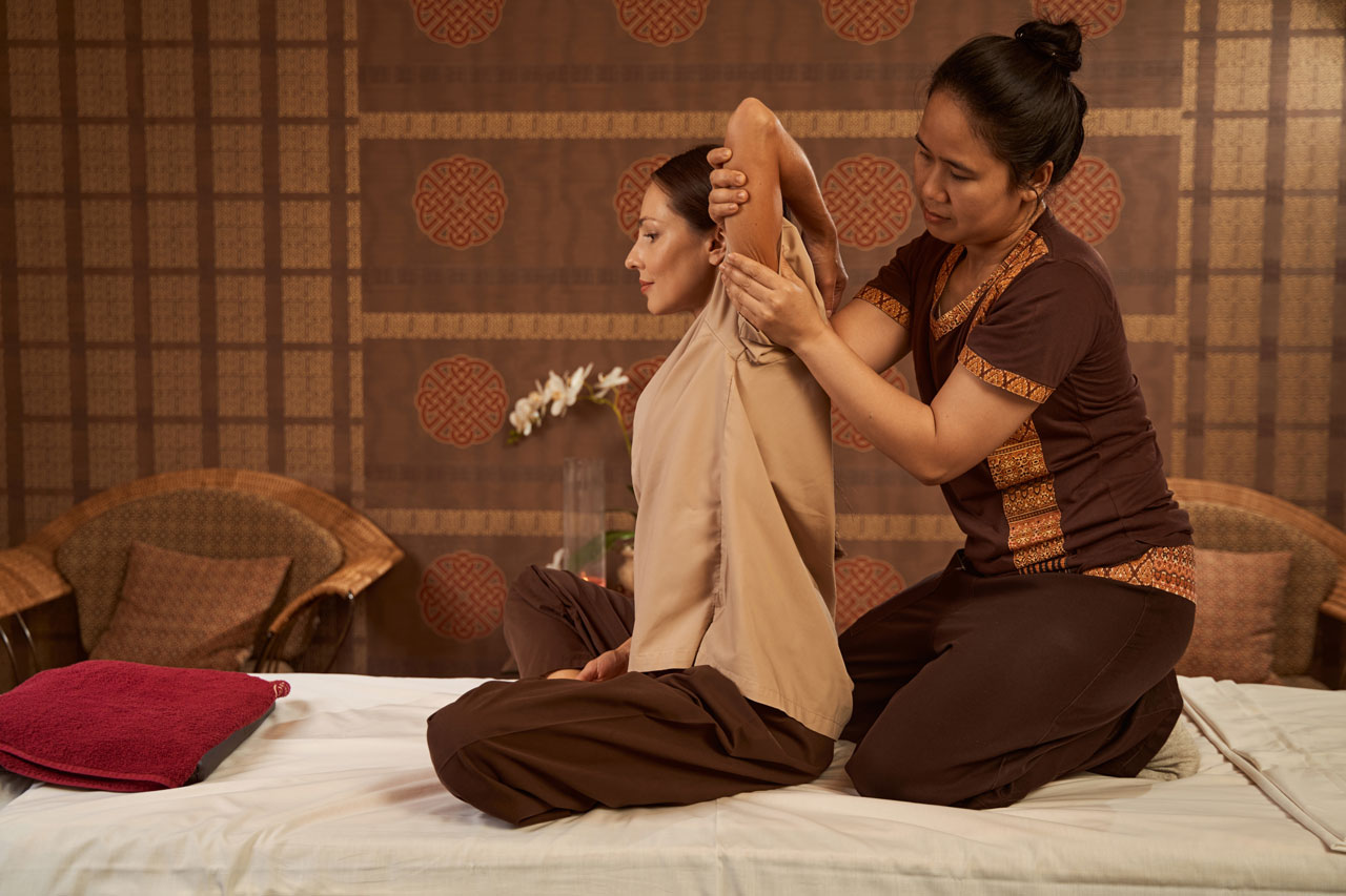 Lady performing Thai massage